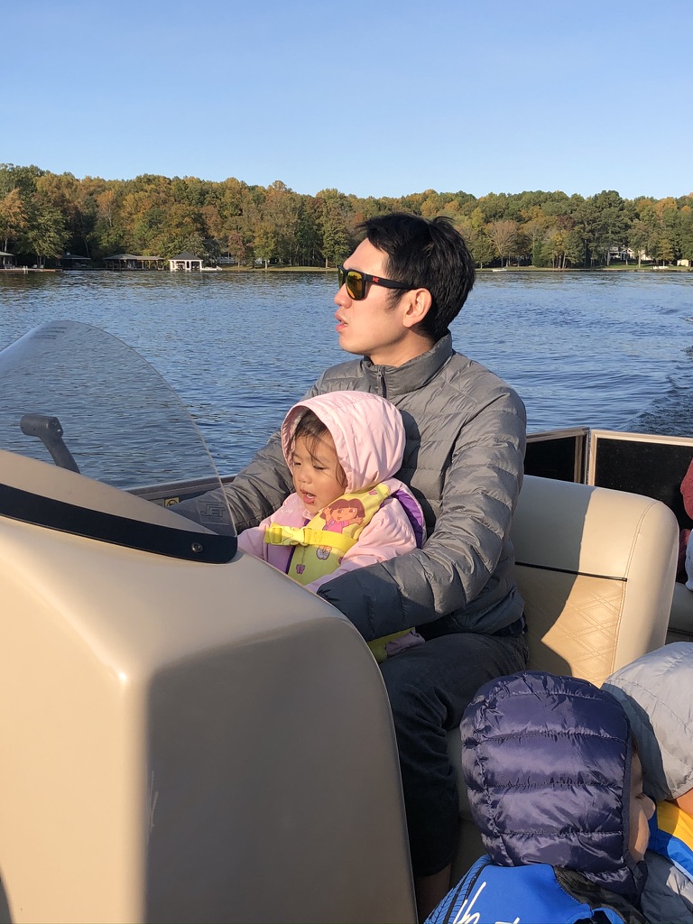 Avery and Daddy driving the boat